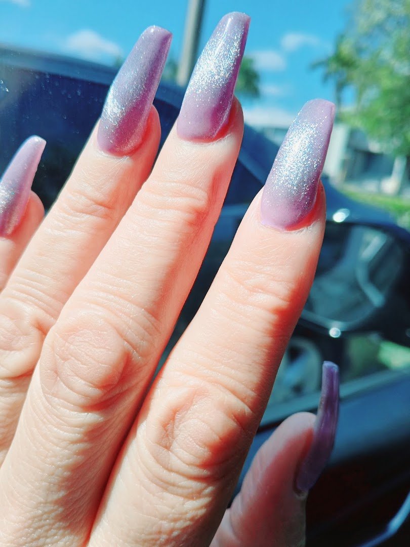 Manicured hands with glossy pink nails.