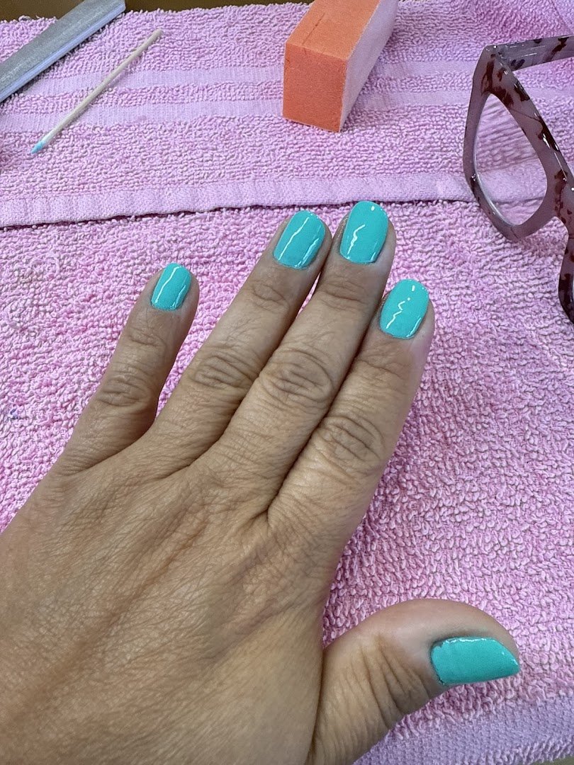 Pedicure chair beside bright salon decor.